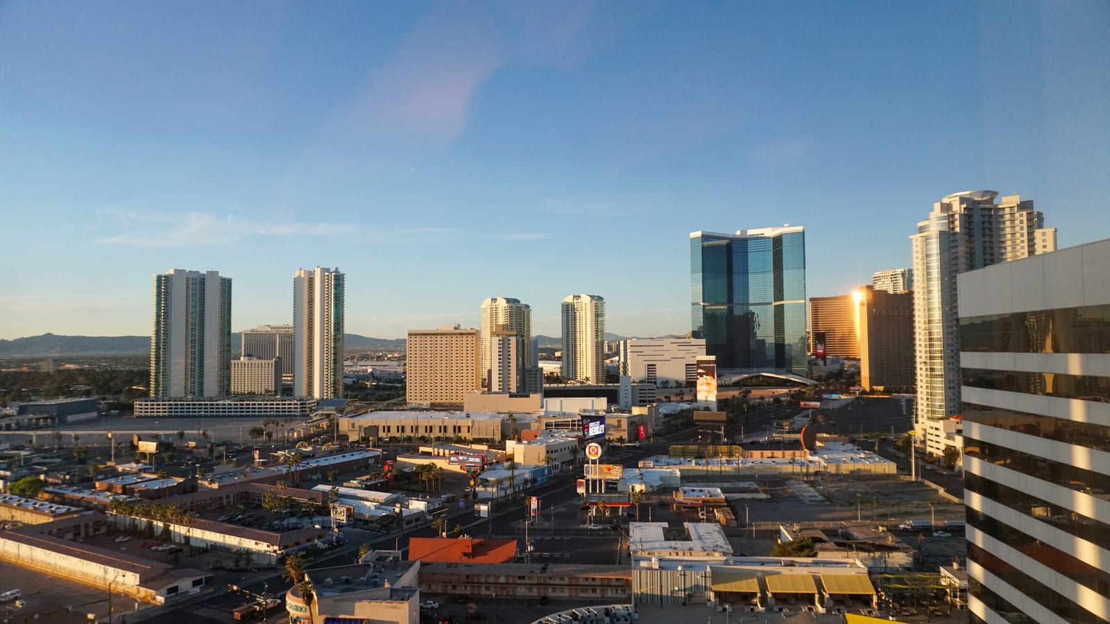 The north end of the Las Vegas Strip at golden hour, shot from a high floor.